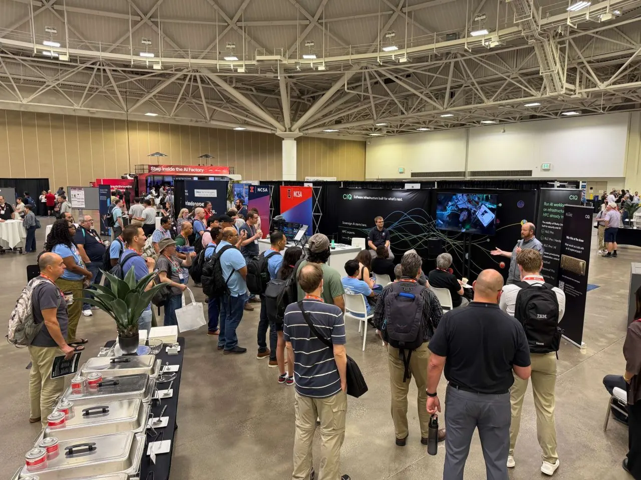 A crowd gathered around the CIQ booth for a talk in the PEARC exhibit hall