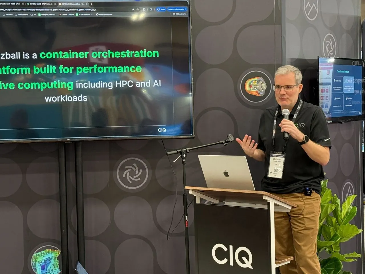 A CIQ engineer at a podium presenting a slide about Fuzzball